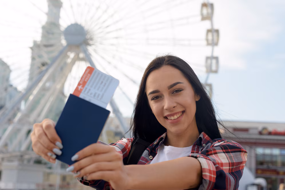 portrait-smiling-woman-showing-air-ticket-passport_23-2148203108
